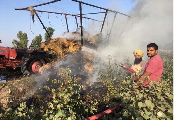 the ashes of burning tractor trolley along with paralysis