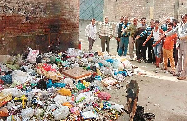 dirt and garbage piles that appear in front of the temple of education