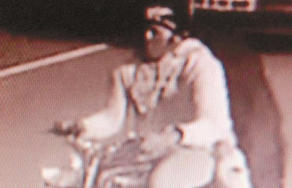the motorcycle aboard a woman carrying a purse