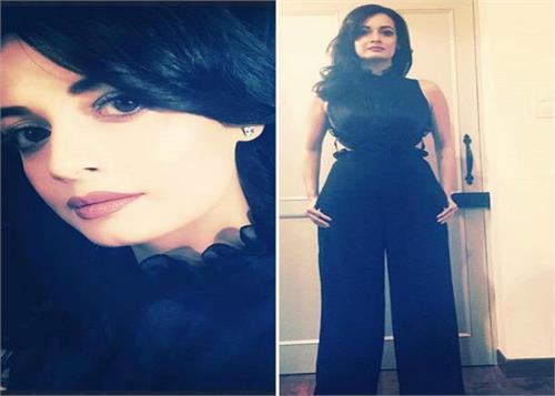 view of the black jump suit stylish look