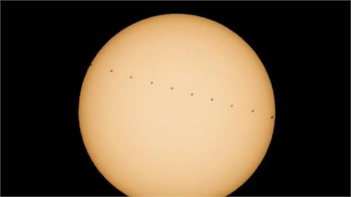 nasa captures image of iss crossing sun