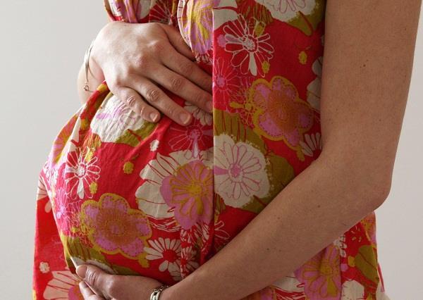 pregnant women sit cross made river on shoulders