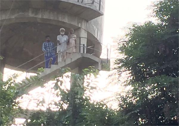 three members of the same family climbed a water work tank