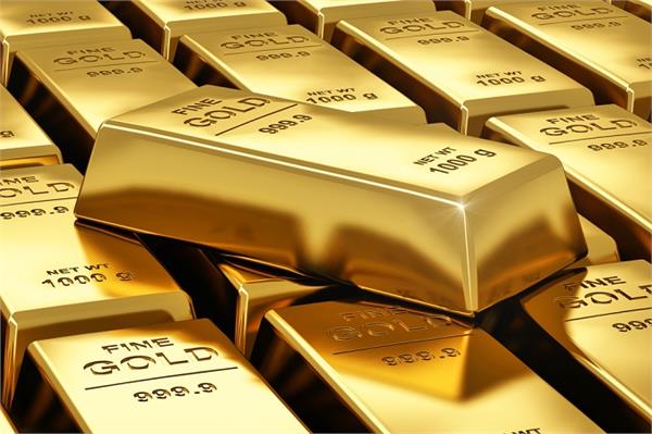 gold inches lower as dollar gains