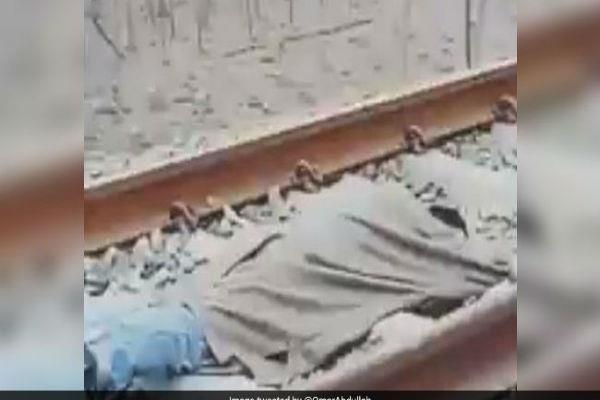 train passes above the young man lying on the track