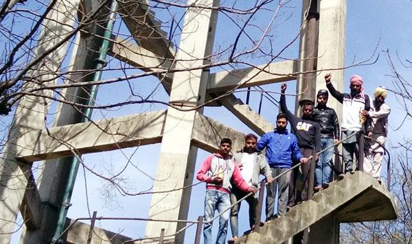 distressed villagers on the tanks carrying petrol bottles