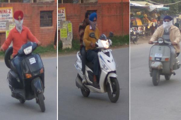 by violating the rules  people are running their heads by covering two wheelers