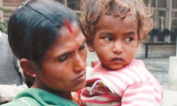 pregnant woman sitting on dharna  3 years old child