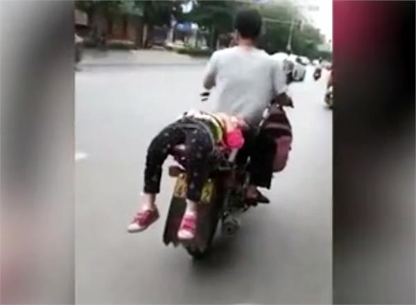 she refused to go to school  so dad tied her onto bike