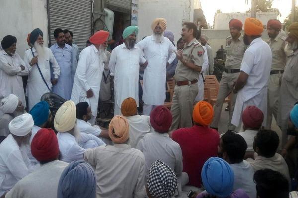 to get liquor contract  the villagers kept dharna