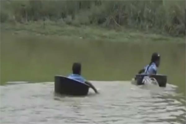 students cross the river using aluminium pots