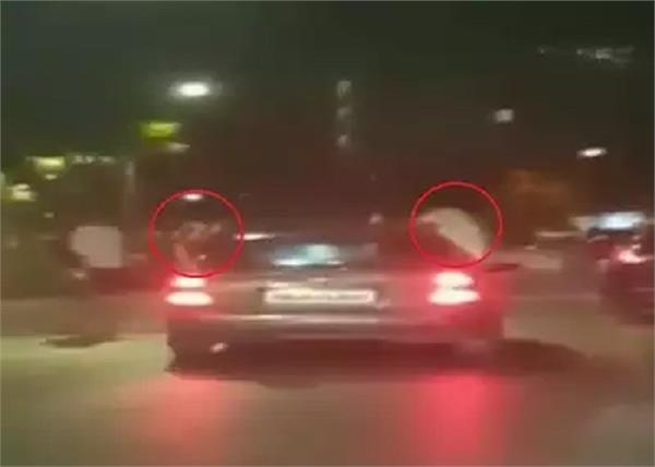 three persons stunts out of the windows car