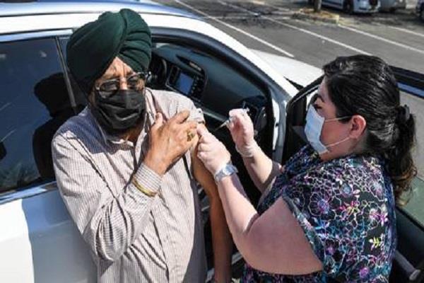 usa  corona vaccine administered to punjabi food and agricultural workers