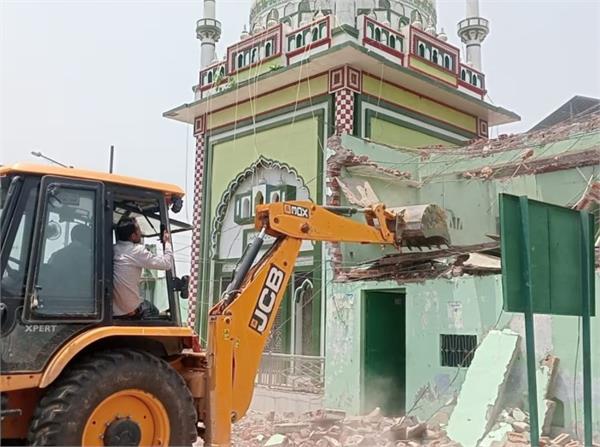muslim community demolishes illegal mosque with bulldozer