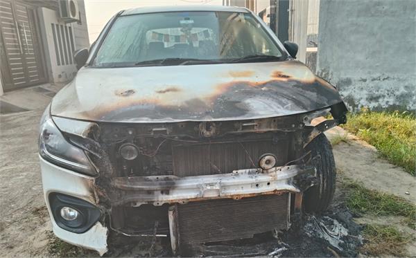 miscreants set fire to a car parked outside a house