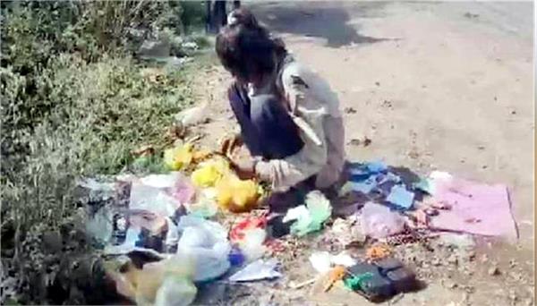 girl seen eating food from garbage