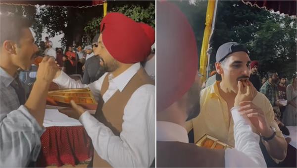 diljit dosanjh treats varun dhawan  ahan shetty with ladoos