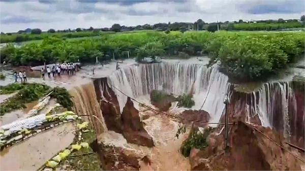 due to heavy rain  the ground sank several feet below  forming a waterfall 