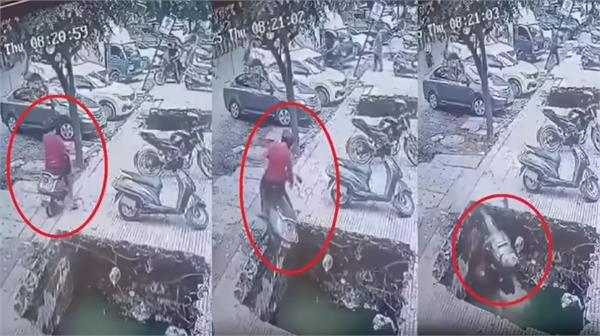 a young man riding a scooter fell into an open drain  the video