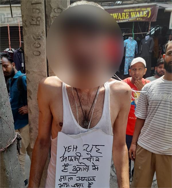 thief beaten up caught stealing a roll of cloth