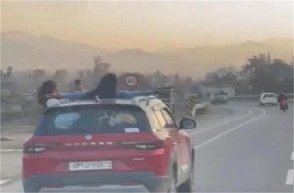 girls stunts moving car sunroof video viral
