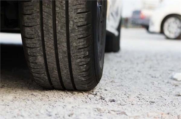 car parked on bricks after stealing tires