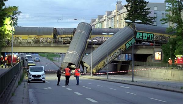 2 carriages fall off bridge after freight train collision in germany