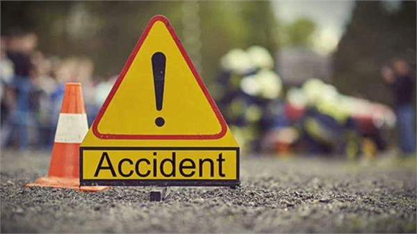 motorcycle collides with parked tractor trolley