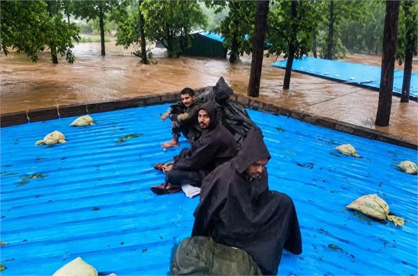 bsf camp  flood water  soldiers  barrack roof  trees