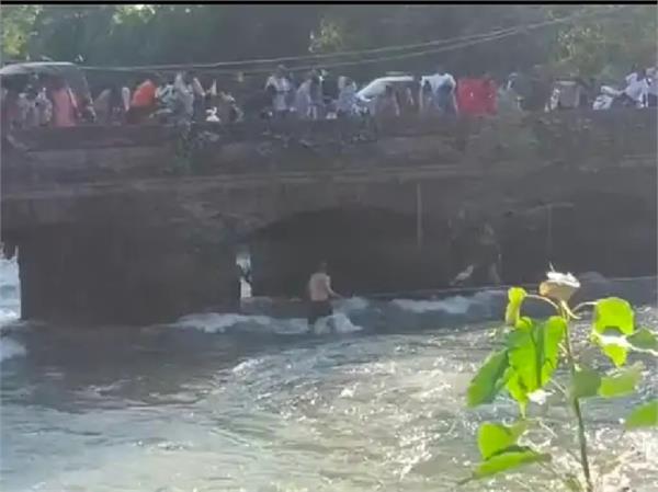 youth falls off narrow canal bridge along with motorcycle